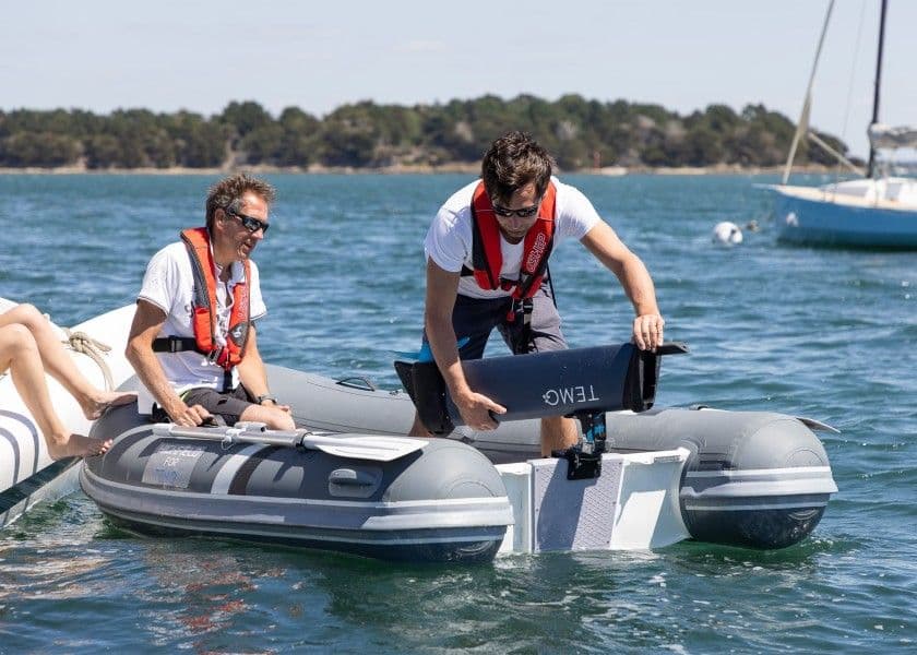 Picture showcasing a man mounting TEMO-1000 on the 360 wheel from inside the dinghy